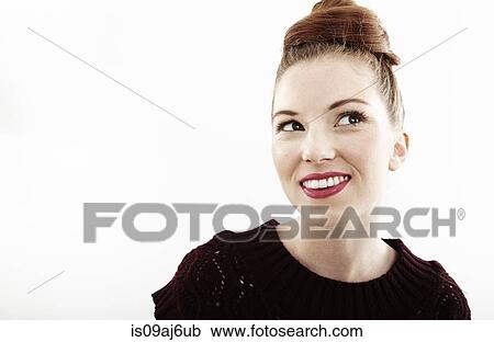 Stock Image - Studio portrait of smiling beautiful young woman. Fotosearch