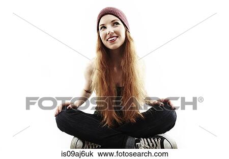 Studio portrait of young woman sitting cross legged on floor View Large Photo Image Stock Image - Studio portrait of young woman sitting cross legged on floor. Fotosearch
