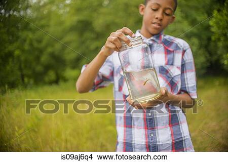 Teenage boy with fish in jar View Large Photo Image Picture - Teenage boy with fish in jar. Fotosearch