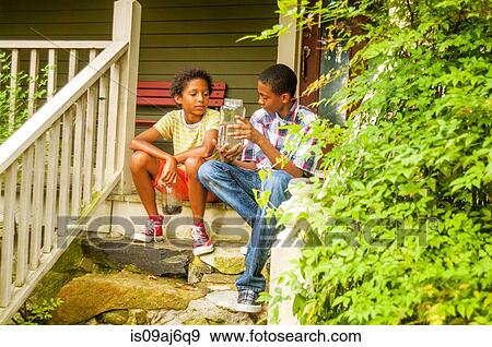 Teenage boy with fish in jar View Large Photo Image Stock Photo - Teenage boy with fish in jar. Fotosearch