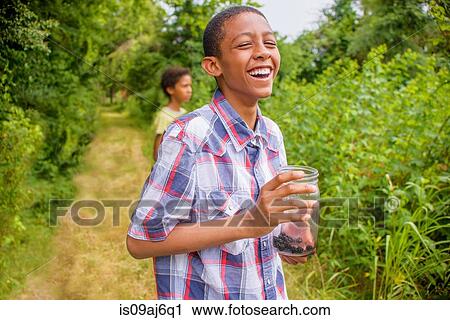 Teenage boys picking berries View Large Photo Image Stock Image - Teenage boys picking berries. Fotosearch