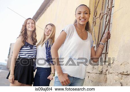 Picture - Teenage girl, friends in background. Fotosearch