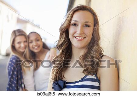 Teenage girl, friends in background View Large Photo Image Stock Photography - Teenage girl, friends in background. Fotosearch