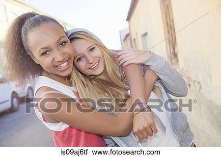 Teenage girls hugging View Large Photo Image Stock Image - Teenage girls hugging. Fotosearch