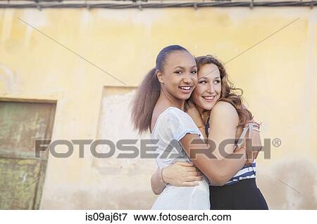 Stock Photo - Teenage girls hugging. Fotosearch
