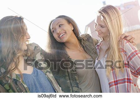Stock Image - Teenage girls laughing. Fotosearch