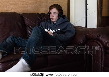 Teenager listening to music at home View Large Photo Image Stock Image - Teenager listening to music at home. Fotosearch