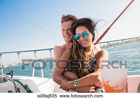 Young couple on boat hugging View Large Photo Image Stock Photography - Young couple on boat hugging. Fotosearch