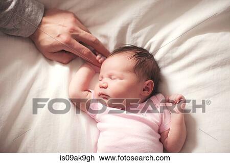Baby girl sleeping, hands held by father View Large Photo Image Stock Image - Baby girl sleeping, hands held by father. Fotosearch