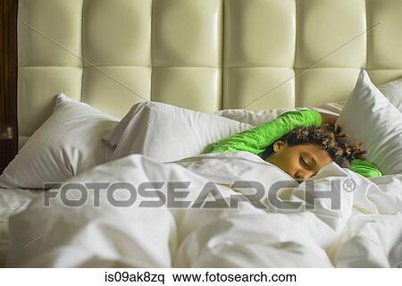 Stock Photography - Boy lying asleep in bed. Fotosearch