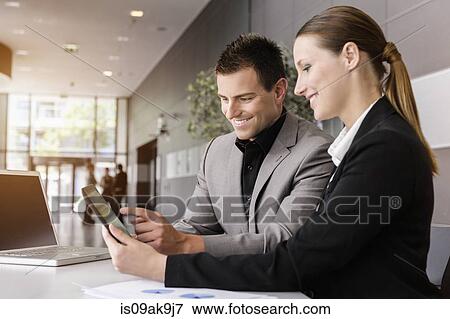 Businesswoman and businessman using digital tablet for discussion View Large Photo Image Stock Photo - Businesswoman and businessman using digital tablet for discussion. Fotosearch