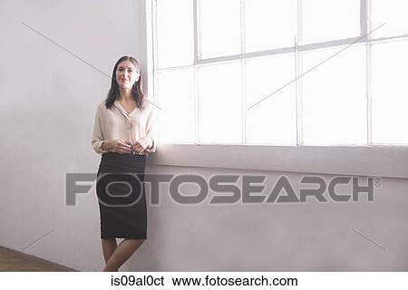 Stock Photograph - Businesswoman by window, portrait. Fotosearch