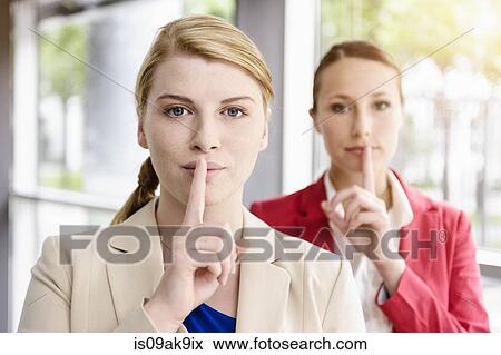 Businesswomen sharing secret View Large Photo Image Stock Photo - Businesswomen sharing secret. Fotosearch