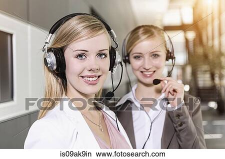 Call centre team wearing headsets View Large Photo Image Picture - Call centre team wearing headsets. Fotosearch