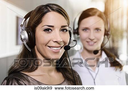 Call centre team wearing headsets View Large Photo Image Stock Photo - Call centre team wearing headsets. Fotosearch
