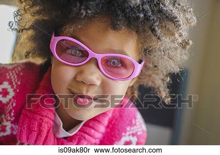 Stock Photography - Close up portrait of girl in pink sunglasses. Fotosearch