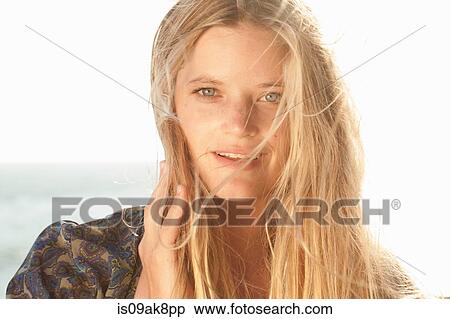Stock Photography - Close up portrait of young woman at the coast, Malibu, California, USA. Fotosearch