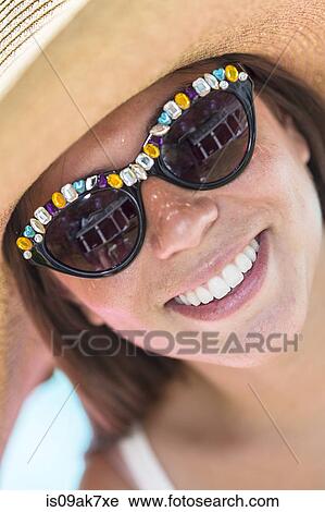 Close up portrait of young woman wearing sunglasses and sunhat View Large Photo Image Stock Image - Close up portrait of young woman wearing sunglasses and sunhat. Fotosearch