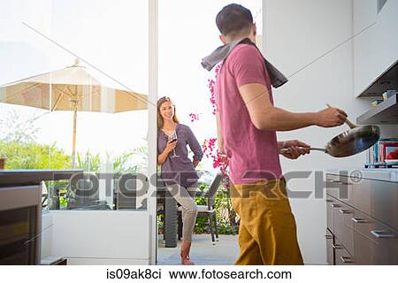 Couple cooking and drinking wine in kitchen View Large Photo Image Stock Image - Couple cooking and drinking wine in kitchen. Fotosearch