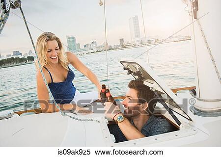 Couple on sailing boat with beer View Large Photo Image Stock Photography - Couple on sailing boat with beer. Fotosearch