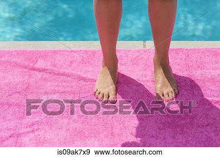 Cropped shot of young womans legs and feet standing on pink beach towel poolside View Large Photo Image Stock Photo - Cropped shot of young womans legs and feet standing on pink beach towel poolside. Fotosearch