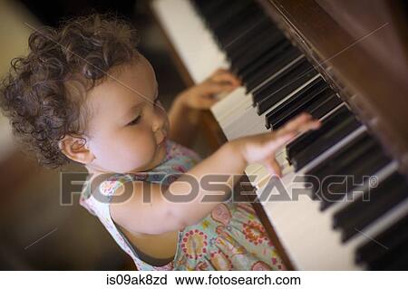 Cute baby girl playing piano View Large Photo Image Stock Image - Cute baby girl playing piano. Fotosearch