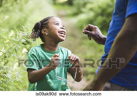 Father and daughter looking at plants in forest eco camp View Large Photo Image Stock Image - Father and daughter looking at plants in forest eco camp. Fotosearch
