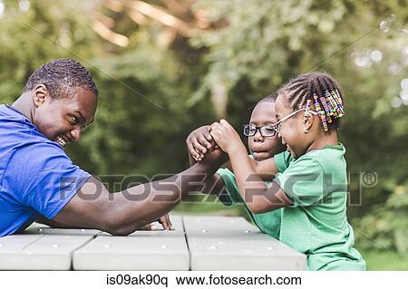 Father arm wrestling with daughter at parkland eco camp View Large Photo Image Stock Photography - Father arm wrestling with daughter at parkland eco camp. Fotosearch