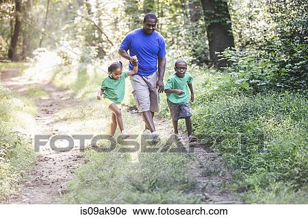 Father walking through forest with daughter and son at eco camp View Large Photo Image Stock Image - Father walking through forest with daughter and son at eco camp. Fotosearch
