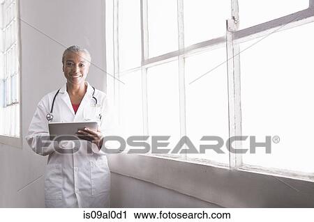 Female doctor holding digital tablet, portrait View Large Photo Image Stock Image - Female doctor holding digital tablet, portrait. Fotosearch