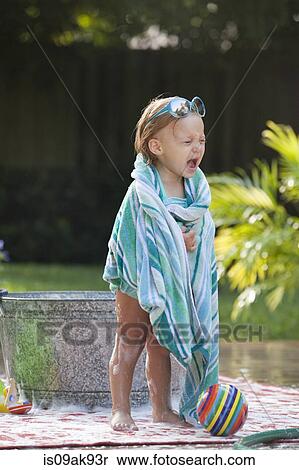 Female toddler wrapped in towel crying beside bubble bath in garden View Large Photo Image Stock Photography - Female toddler wrapped in towel crying beside bubble bath in garden. Fotosearch