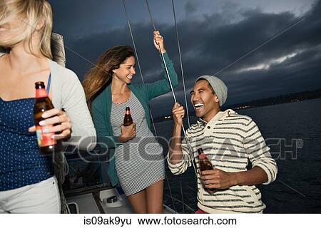 Friends on sailing boat with beer View Large Photo Image Stock Photograph - Friends on sailing boat with beer. Fotosearch
