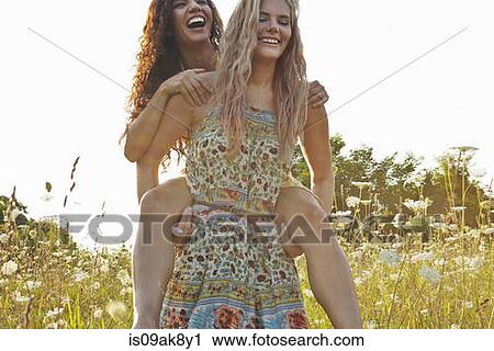 Friends playing piggy back View Large Photo Image Stock Image - Friends playing piggy back. Fotosearch