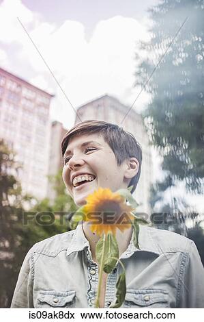 Stock Photo - Happy woman with flower. Fotosearch
