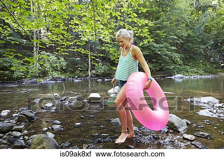 Hiker in forest with inflatable ring View Large Photo Image Stock Image - Hiker in forest with inflatable ring. Fotosearch