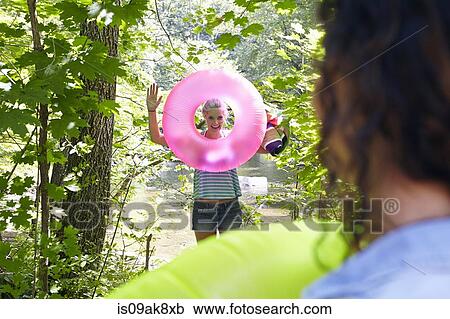 Hikers in forest with inflatable ring View Large Photo Image Stock Image - Hikers in forest with inflatable ring. Fotosearch