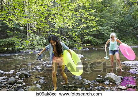 Stock Image - Hikers in forest with inflatable ring. Fotosearch