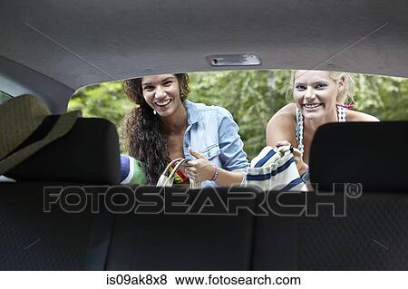 Hikers looking through rear of car View Large Photo Image Stock Photo - Hikers looking through rear of car. Fotosearch