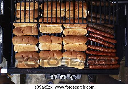 Stock Photo - Hot dogs on bbq. Fotosearch