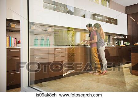 Loved up couple cooking on hob in kitchen View Large Photo Image Stock Image - Loved up couple cooking on hob in kitchen. Fotosearch