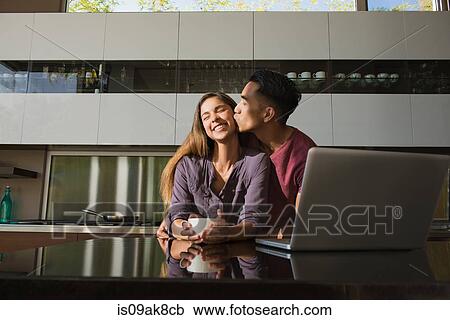 Loved up couple in dining room drinking coffee View Large Photo Image Stock Image - Loved up couple in dining room drinking coffee. Fotosearch