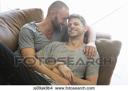 Male couple reclining on sitting room sofa View Large Photo Image Picture - Male couple reclining on sitting room sofa. Fotosearch