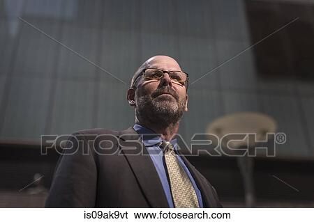 Mature businessman, low angle portrait View Large Photo Image Stock Photograph - Mature businessman, low angle portrait. Fotosearch