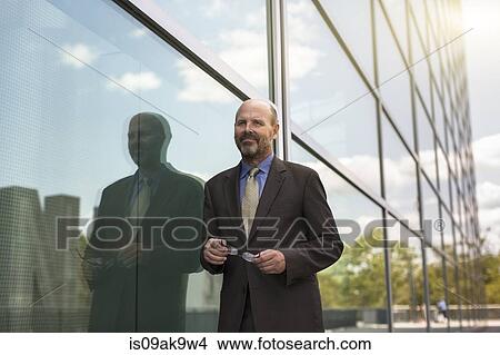 Picture - Mature businessman outside building. Fotosearch