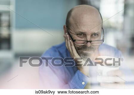 Mature businessman wearing glasses with coffee View Large Photo Image Stock Photo - Mature businessman wearing glasses with coffee. Fotosearch