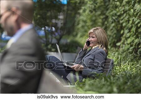 Mature businesswoman on phone with laptop View Large Photo Image Stock Photograph - Mature businesswoman on phone with laptop. Fotosearch