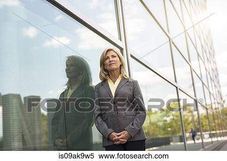 Mature businesswoman outside building View Large Photo Image Stock Photography - Mature businesswoman outside building. Fotosearch
