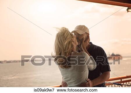 Mature couple kissing on passenger ferry View Large Photo Image Stock Photo - Mature couple kissing on passenger ferry. Fotosearch