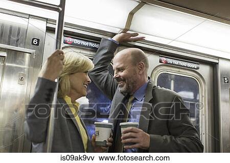 Stock Photo - Mature couple on subway train. Fotosearch