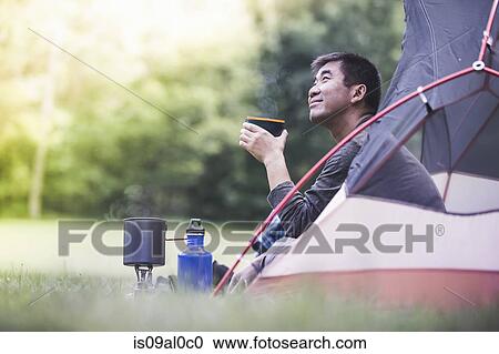 Mature man in tent with hot drink View Large Photo Image Stock Image - Mature man in tent with hot drink. Fotosearch